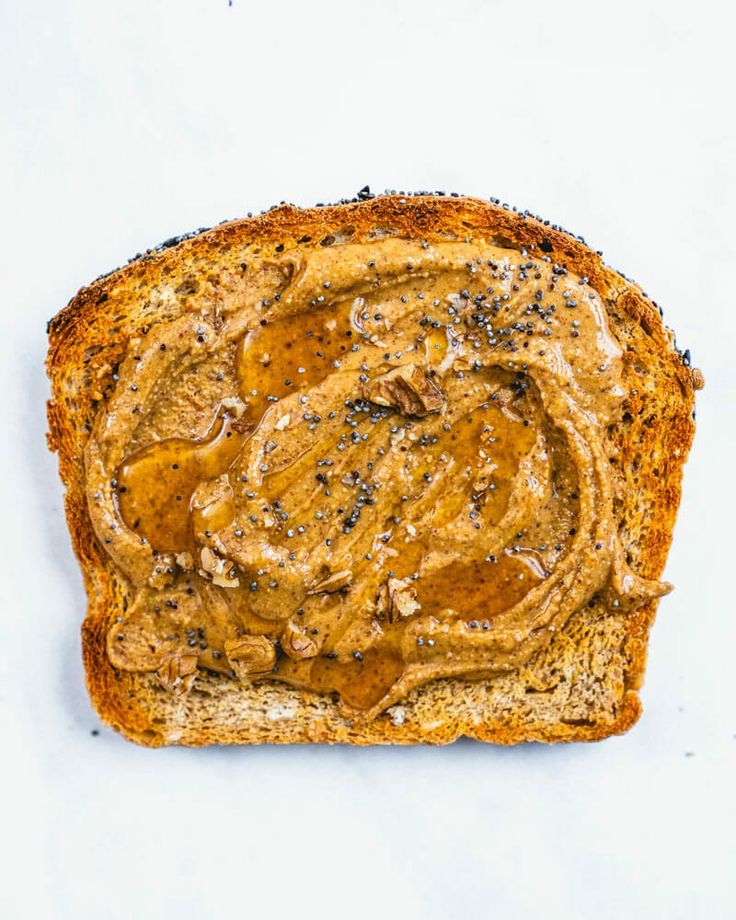 almond nut butter spread on bread with white background